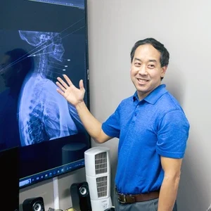 Dr. Zen Matsuda displaying x-rays during a patient consultation